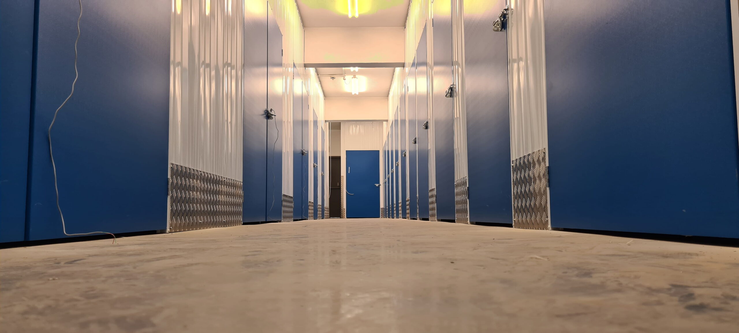 Indoor self storage corridor with secure rooms at Trunk Self Storage Grays Essex