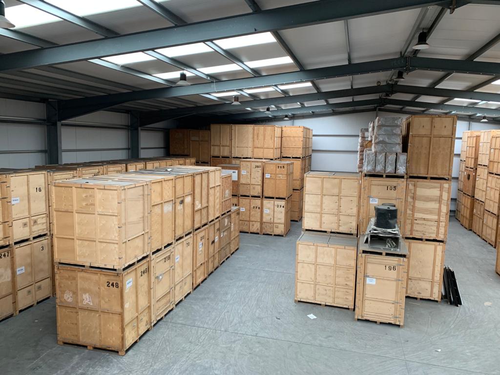 Large secure warehouse with stacked wooden storage crates in Grays Essex