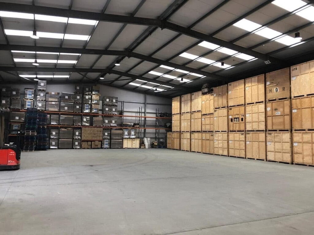 Secure indoor warehouse with stacked crates and pallet racking in Essex