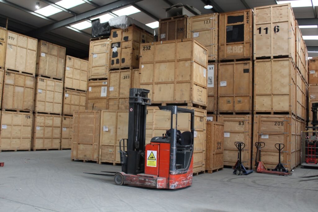 Large commercial warehouse interior at Trunk Logistics Grays showing forklift and extensive wooden crate storage capacity