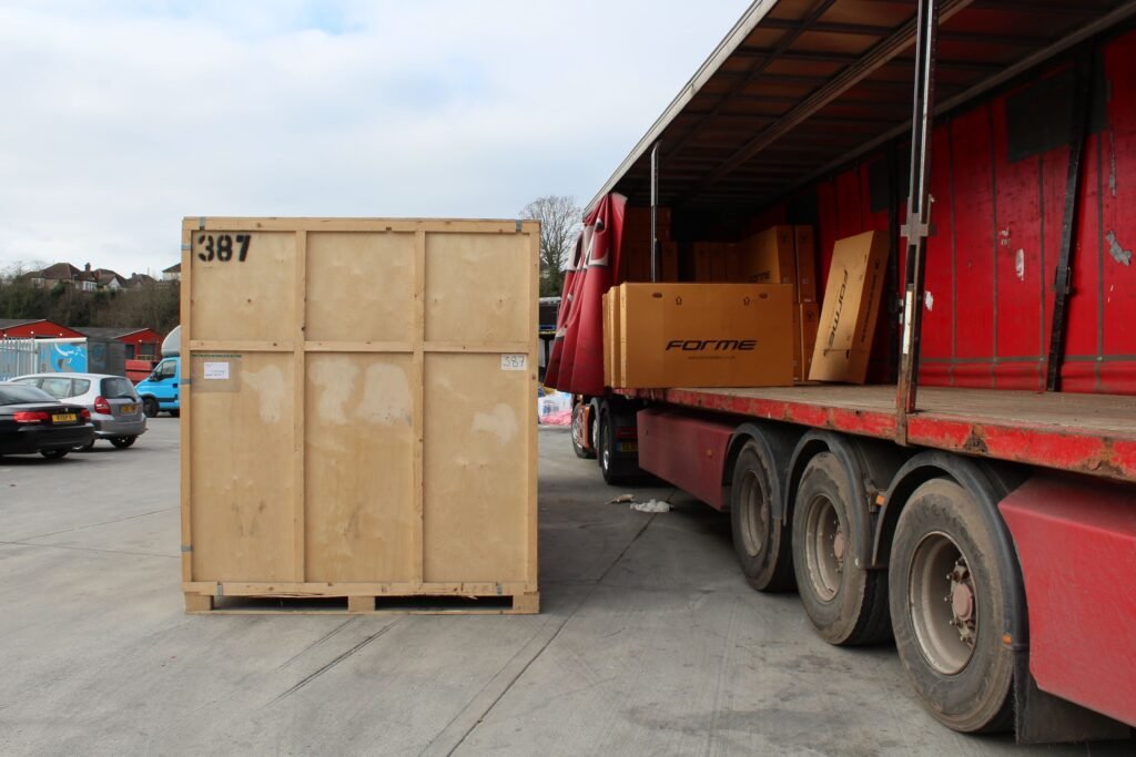 Last Mile Warehousing for London, Essex and Kent Large Forme bike boxes on delivery vehicle at Trunk Logistics Grays Essex warehouse with numbered storage crate in yard
